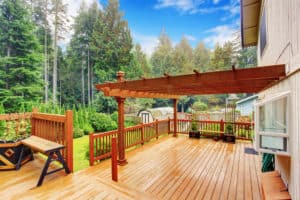 clean wooden stained deck with attached pergola