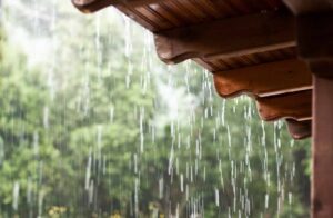 overflowing gutters rain water pouring off roof