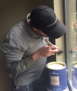 HomeSquare technician painting window trim