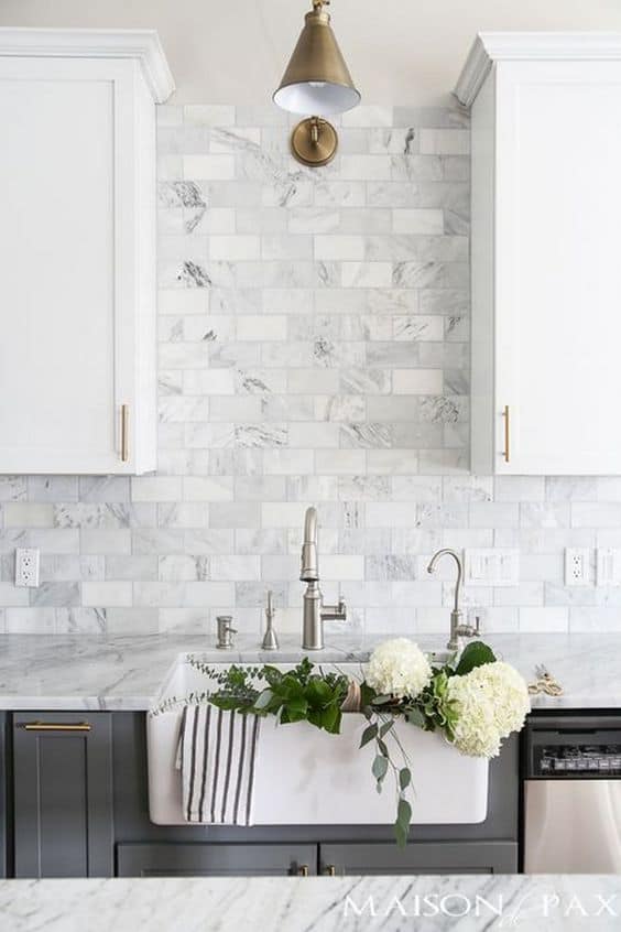 Subway style tile used for backsplash behind kitchen sink