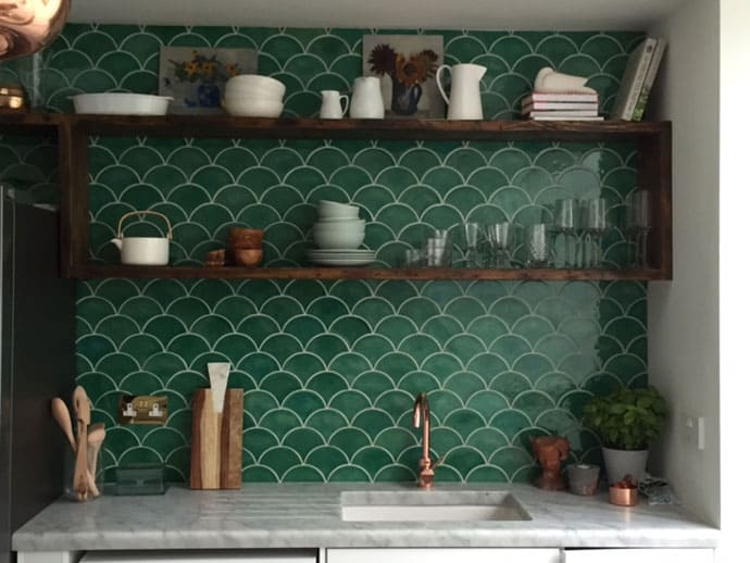 Douglas Watson Studio with a dark green scallop “belly up” on a backsplash