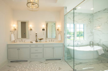 In this transitionally styled bathroom a large wet room features a freestanding tub and a shower decked in marble. It makes the bathroom feel larger, and eliminates the feeling of being cramped in a shower. If you’re using the tub, you can simply hop out and shower off without dripping water all over the bathroom.