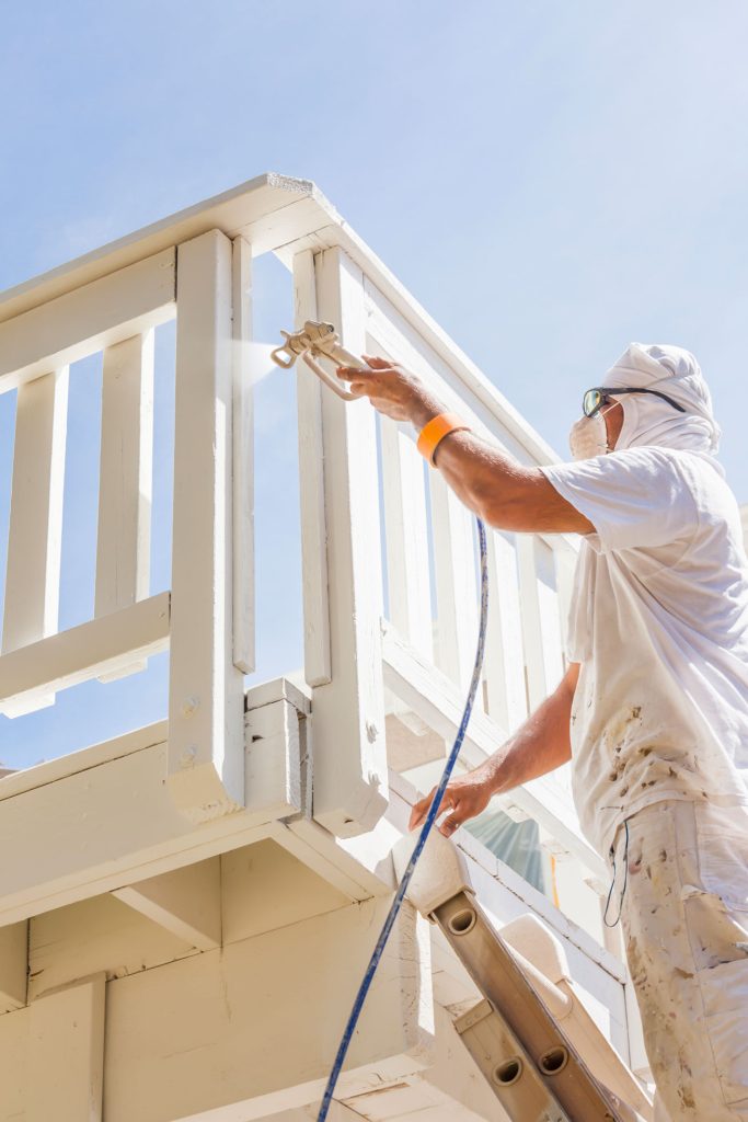 man spray painting wood exterior on sunny day 2026 01 05 00 26 35 utc 683x1024 man spray painting wood exterior on sunny day 2026 01 05 00 26 35 utc 683x1024